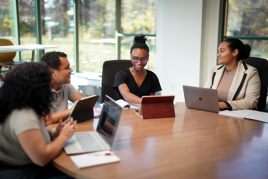 Four students work at open laptops at Western Michigan University.